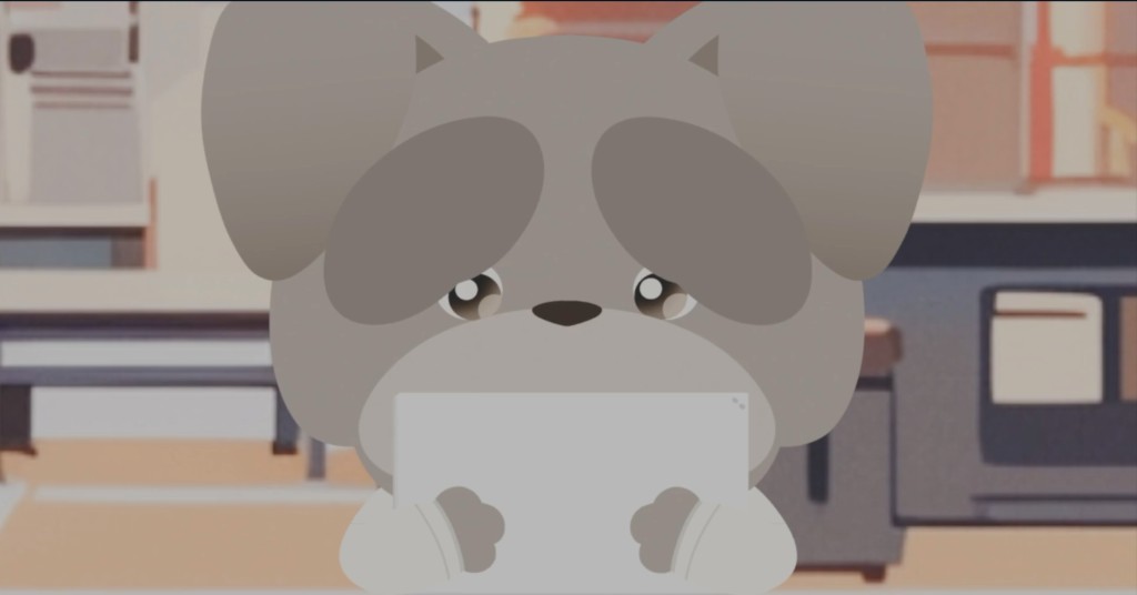 室内を背景に、涙ぐんだ大きな目の灰色の子犬キャラクターが、両手で薄い長方形の物を抱えてこちらを見ているイラスト